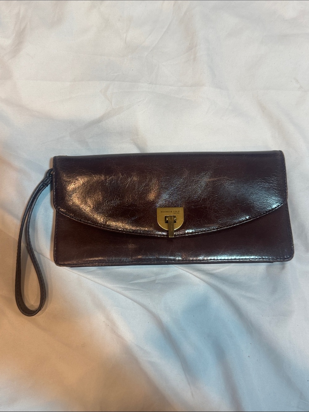 Kenneth Cole dark brown leather wristlet clutch with gold-tone lock